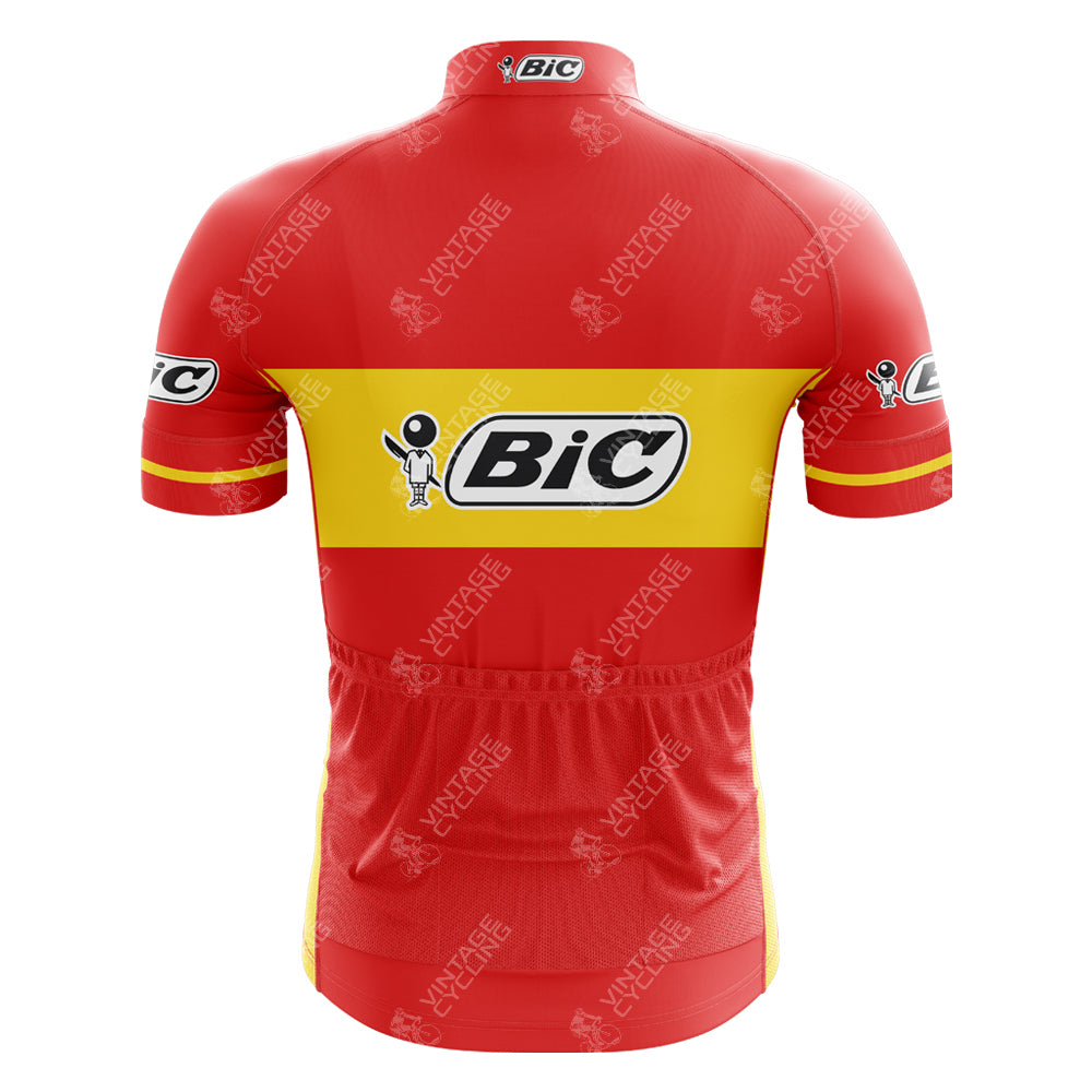 This BIC Spain Short Sleeve Retro Cycling Jersey features a vibrant red and yellow design with the BIC logo boldly displayed on the back and sleeves. Made from lightweight polyester, it honors Tour de France winners with its distinctive style.