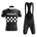 Front view of the PEUGEOT Black Retro Short Sleeve Cycling Set, featuring a jersey and bib shorts with bold white PEUGEOT text, a checkered pattern, green BP logo patches on the jersey, and distinctive white text details on the bib shorts leg.