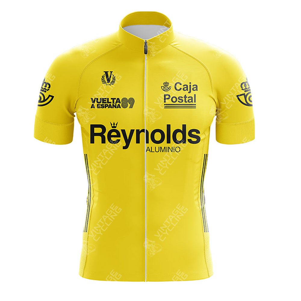 The Del Tongo-MG Maglificio Retro Short Sleeve Cycling Set is a bright yellow jersey with black text and logos, featuring Reynolds ALUMINIO, Caja Postal, Vuelta a España, and sponsor logos on the chest and sleeves.