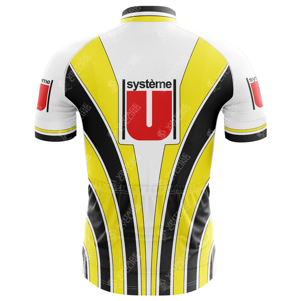 The Système U Gitane Retro Cycling Jersey features a back view with a vintage white, yellow, and black color scheme. It displays système U branding and red and black logos on the upper back, enhanced by vertical stripes reminiscent of the Gitane racing bike era.