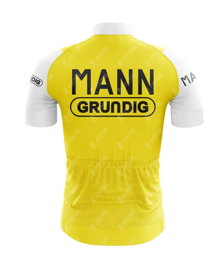 The back of the Mann Grundig Retro Cycling Jersey features MANN in bold black above GRUNDIG on a yellow and white design. Made from lightweight polyester, it includes three rear pockets and subtle logo patterns with sleeve logos for a classic look.