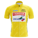 The Carrera Jeans 1987 Tour de France Retro Cycling Jersey is a vibrant yellow piece adorned with logos such as Carrera Jeans, Vagabond, Le Parisien, and Credit Lyonnais. It features a zippered front and short sleeves in classic Tour de France style.