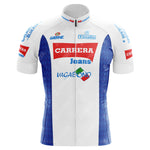 The Carrera Jeans 1987 Retro Cycling Jersey features a white central panel with CARRERA Jeans and VAGABOND logos, reminiscent of Stephen Roches cycling era, blue side panels with sponsor logos on the sleeves and collar, and a front zipper closure.