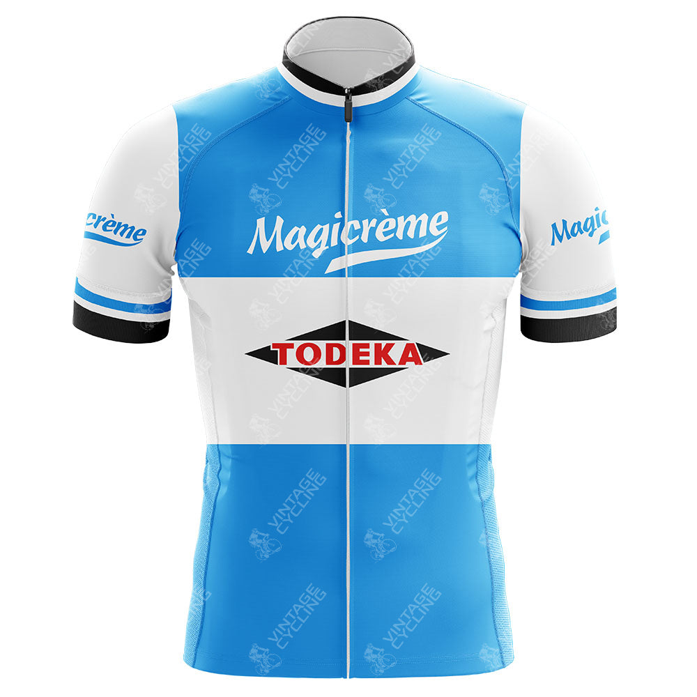 The Todeka Magicreme Retro Cycling Jersey is a blue and white retro jersey showcasing Magicreme in bold white on the chest, with Todeka in red and black on a white base. Made from lightweight polyester, it includes a silicone waist strip for a perfect fit and features a subtle Vintage watermark.