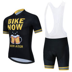 The Bike Now Beer Later Cycling Jersey Set includes a black, beer-themed jersey with BIKE NOW BEER LATER and clinking mugs. Yellow and white stripes enhance the sleeves and shorts. The bib shorts feature a gel seat pad for comfort on long rides.