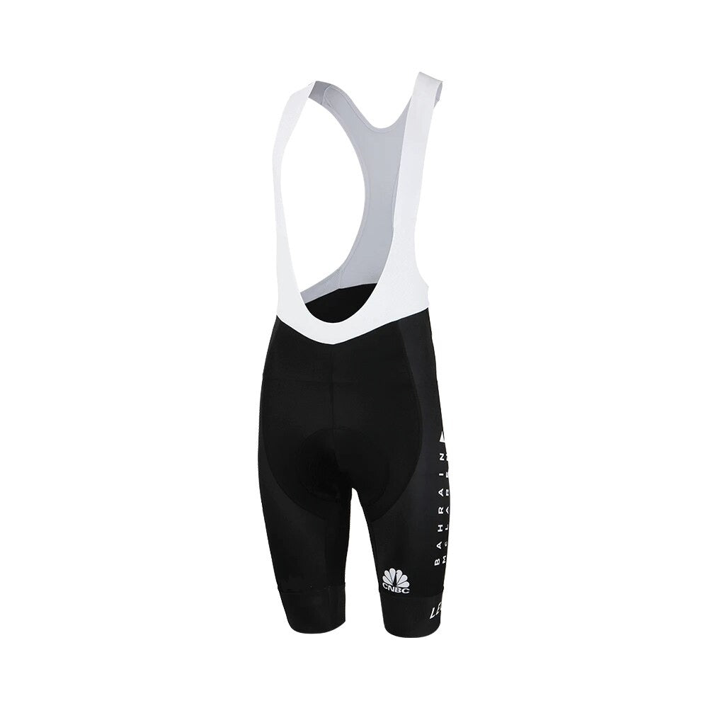 The Bahrain McLaren Le Col Bib Shorts feature a black and white design with attached straps, offering a minimalist and sporty aesthetic. Their sides display small vertical text similar to a cycling team jersey, perfect for cycling enthusiasts.