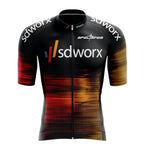 The SD Worx Cycling Jersey, made from lightweight polyester, features black, red, and orange horizontal streaks. It includes short sleeves and a front zipper for comfort and style during rides.