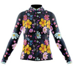 The Womens Long Sleeve Floral Big Yellow Jersey features a vibrant floral pattern with yellow, pink, and blue flowers on a dark background, full zip design, and high collar. Available with a fleece option for cooler rides.