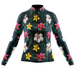 The Womens Long Sleeve Floral Big Yellow Pink Cycling Jersey features a vibrant floral pattern with pink, white, and yellow flowers on a black background. It has a sleek, fitted cut and cozy fleece lining for warmth.