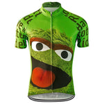 The Oscar the Grouch Sesami Street Retro Cycling Jersey in green features a large cartoon face inspired by Oscar the Grouch, including bushy eyebrows and a wide-open mouth. The jersey has text on the sleeves and sides and comes with a full front zipper.