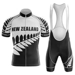 The New Zealand Pro Team Cycling Jersey Sets feature a black and white design with New Zealand and a stylized fern. The jersey has short sleeves, a full zipper, and is made from lightweight polyester. Bib shorts have shoulder straps for comfort.