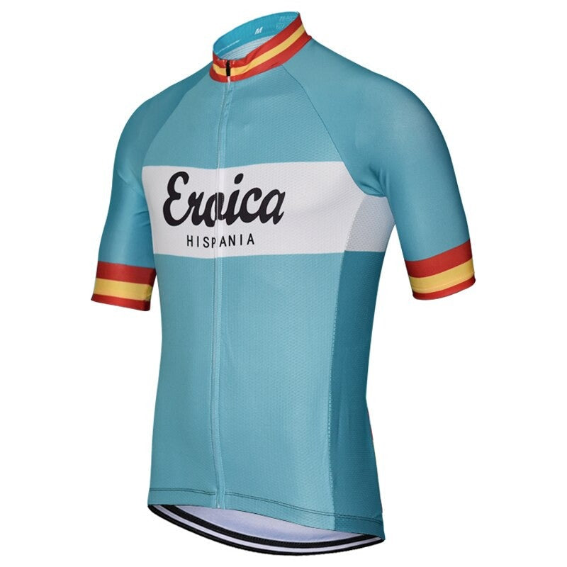 The Eroica Hispania Retro Cycling Jersey features a teal body and sleeves, a white band with Eroica Hispania in black, and sleeve cuffs with red, yellow, and orange stripes, embodying classic cycling style.