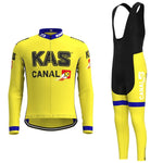 The KAS Canal Retro Cycling Jersey Long Set features a yellow and black design with KAS and CANAL 10 branding, along with blue and red accents. It includes matching bib tights and offers an optional fleece choice for cooler rides or breathable shorts for comfort.