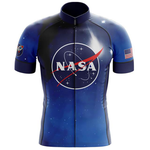 Check out our NASA Blue Cycling Jersey, made from lightweight polyester. It features the classic NASA logo at its center, star patterns across the fabric, a space shuttle patch on the right sleeve, and an American flag patch on the left.