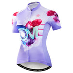 Discover our Womens Love Cycling Jersey made from lightweight polyester, featuring a colorful abstract heart design with LOVE in purple, pink, and blue. It has a convenient zippered front. Check our size guide for the perfect fit.