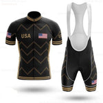 Black and gold, lightweight polyester cycling jersey set with bold chevron patterns featuring USA text and a USA flag on both the jersey and bib shorts, inspired by the USA Cycling Team Jersey.
