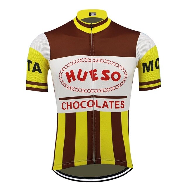Hueso Chocolates Retro Cycling Jersey features brown, yellow, and white stripes with Hueso Chocolates in bold red on the front. Reminiscent of a Spanish Cycling Team style, it has short mesh sleeves with MOTA in black on a yellow band and a full center zipper.