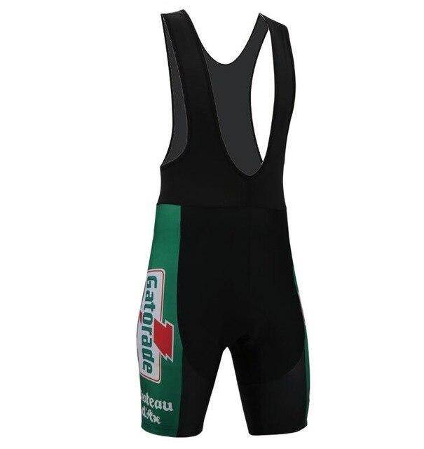 Chateau dAx Gatorade Bib Shorts: Black cycling bib shorts with green side panels, large Gatorade logo, and Chateau dAx in white text. Designed for the cycling team with a gel pad seat for comfort and mesh-like straps. Displayed against a plain white background.