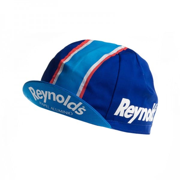 The Reynolds Retro Cycling Cap is a vintage blue cap featuring Reynolds on the side and brim, with striking red, white, and light blue stripes running front to back.
