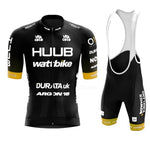 The Huub Wattbike Cycling Team Jersey Set includes a black and yellow jersey with short sleeves, front zipper, sponsor logos like Durata and Argon 18, and bib shorts featuring a seat pad for better performance, made from lightweight polyester.