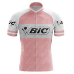 The BIC Pink Retro Short Sleeve Cycling Set is a vintage jersey featuring black BiC logos on the chest and sleeves, a stick figure icon, front zipper, and stand-up collar—ideal for cycling enthusiasts.