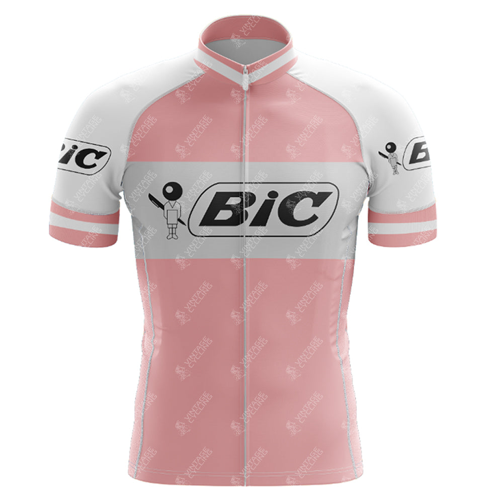 The BIC Pink Retro Short Sleeve Cycling Set is a vintage jersey featuring black BiC logos on the chest and sleeves, a stick figure icon, front zipper, and stand-up collar—ideal for cycling enthusiasts.