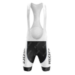 The front view of the Peugeot Black White Retro Short Sleeve Cycling Set shows vintage cycling bib shorts featuring a white and black color scheme with PEUGEOT vertically on the sides, shoulder straps, and a padded seat area.