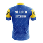 Back view of the Mercier Retro Short Sleeve Cycling Set highlights a blue and yellow jersey with Mercier Hutchinson on the back. It features a high collar, back pockets, short sleeves, and BP logos for a classic appearance.