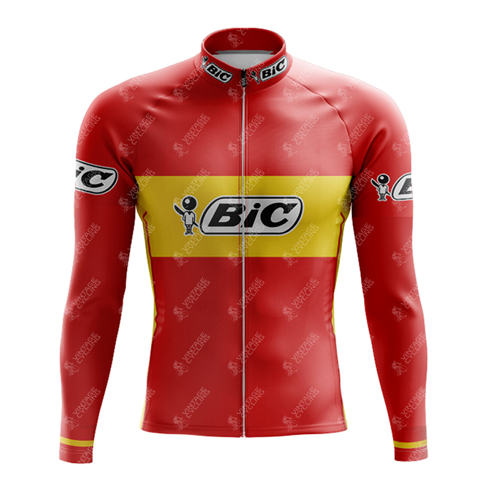The BIC Red Retro Long Sleeve Cycling Jersey features a red and yellow design with BIC on the chest and sleeves, plus a graphic of a person holding a pen. Part of the BIC Red Retro Cycling Set (fleece option available), it combines style and performance for serious cyclists.