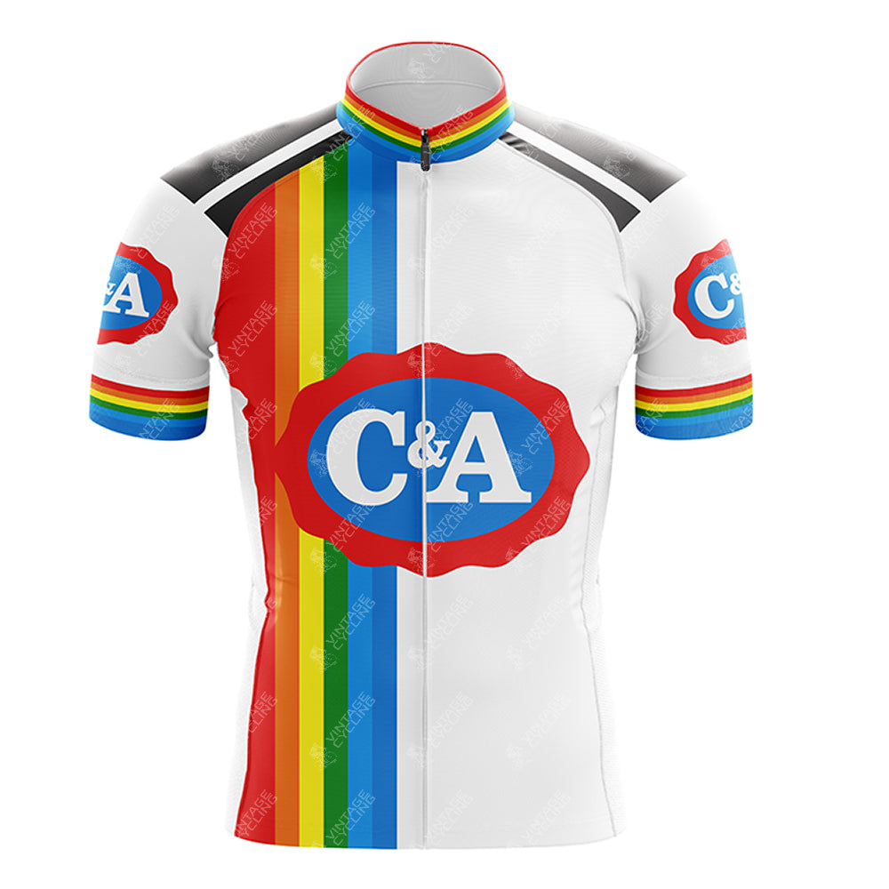 Close-up of the C&A Retro Short Sleeve Cycling Set in white, featuring a central red oval with C&A. Rainbow stripes run vertically on the left, while rainbow bands enhance the sleeves. Black shoulder accents complete the look. See our size guide for various jersey and shorts sizes.