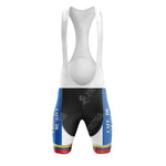 Front view of the Belgium Short Sleeve Cycling Set bib shorts with white straps, black center, blue sides adorned with white text and rainbow stripes at leg openings against a white background, evoking CAFE DE COLOMBIA style.