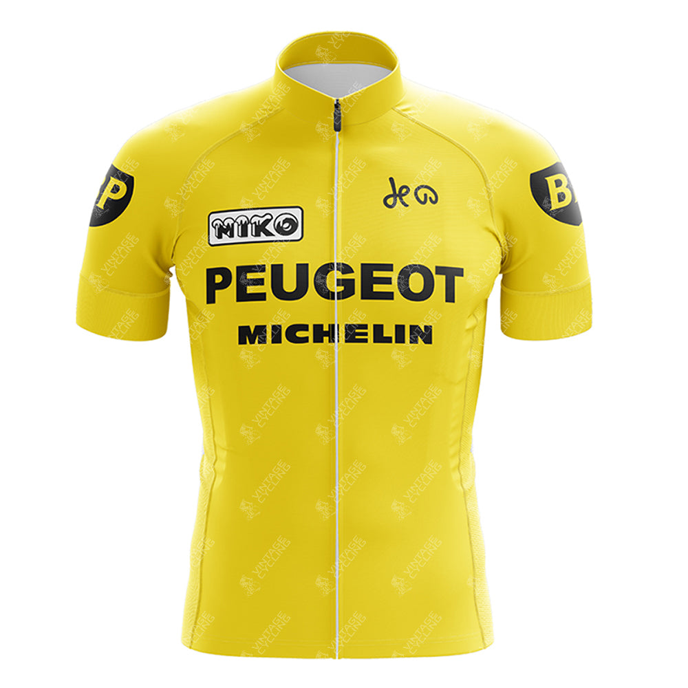 The PEUGEOT Yellow Retro Short Sleeve Cycling Set boasts a vintage look with bold black PEUGEOT and MICHELIN logos on the classic yellow jersey. The sleeves feature a distinct black circle with a yellow BP. A front zipper completes the timeless style.