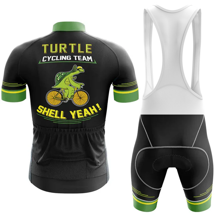 The Wales Men Short Sleeve Cycling Set includes a black and green jersey and bib shorts. The kit features a cartoon turtle on a bike with "Turtle Cycling Team" and "Shell Yeah!" in bold yellow letters on the back.
