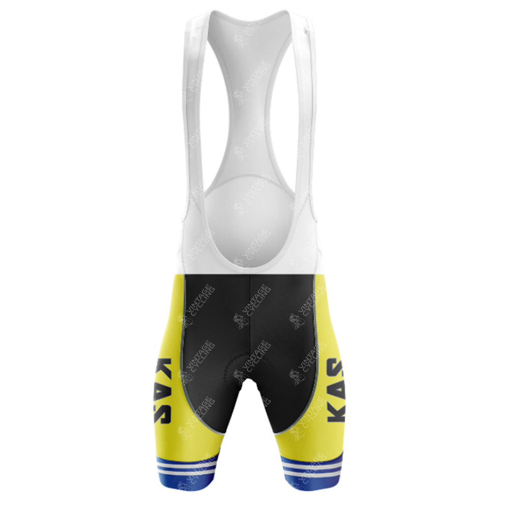 The KAS Yellow Retro Short Sleeve Cycling Set includes retro cycling bib shorts with white straps, showcasing vibrant yellow and black sections and blue horizontal stripes at the bottom. KAS is printed vertically on the thighs, making it an essential piece of the set.