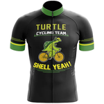 The Wales Men Short Sleeve Cycling Set features a black jersey with green accents, showcasing a cartoon turtle on a yellow bike. "Turtle Cycling Team" and "Shell Yeah!" appear in bold yellow and white letters—perfect for cycling enthusiasts.