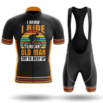 The Dawgs Short Sleeve Cycling Set includes a black jersey and bib shorts with orange and yellow stripes, featuring “I know I ride like an old man. Try to keep up” and a cyclist graphic on a retro sunset background.