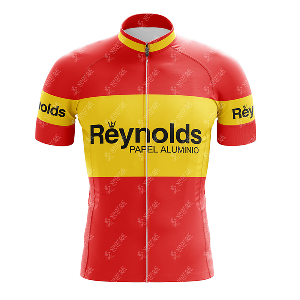 The 1980s red Reynolds Retro Short Sleeve Cycling Set features a vibrant red and yellow jersey with a full front zipper, showcasing Reynolds Papel Aluminio in black on the chest and arms, capturing the classic 1980s look.