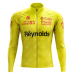 The 1983s yellow Reynolds Retro Long Sleeve Cycling Set (With Fleece Option) showcases Vuelta a España 83, Caja Postal, and Reynolds logos in red and black on the chest and sleeves, perfectly pairing with the gel seat pad for ultimate comfort.