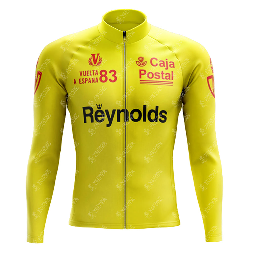The 1983s yellow Reynolds Retro Long Sleeve Cycling Set (With Fleece Option) showcases Vuelta a España 83, Caja Postal, and Reynolds logos in red and black on the chest and sleeves, perfectly pairing with the gel seat pad for ultimate comfort.