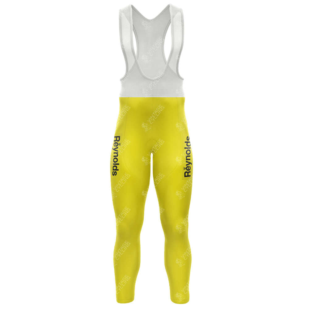 The 1983s Yellow Reynolds Retro Long Sleeve Cycling Set features a cycling bib with black Reynolds text on the sides, white straps, fleece-lined options for warmth, and is designed for full leg coverage for ultimate comfort.