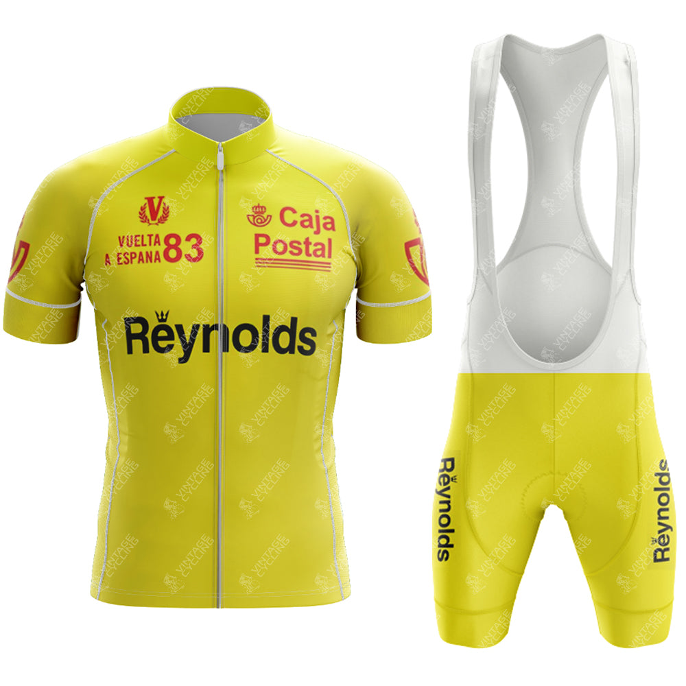 The 1983s yellow Reynolds Retro Short Sleeve Cycling Set includes a jersey and bib shorts with Caja Postal and Reynolds logos. The jersey highlights Vuelta a España 83, accented with white lining for a vintage feel.