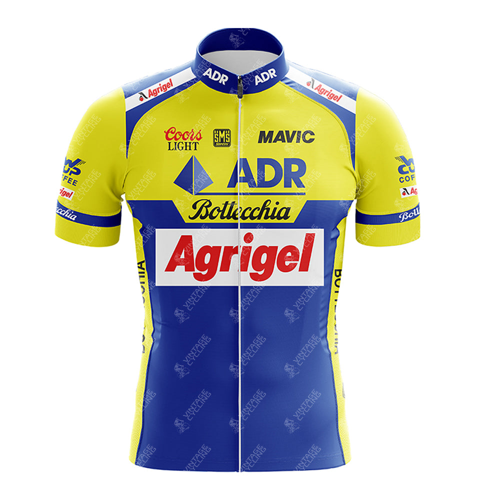 The 1989 ADR Retro Short Sleeve Cycling Set features a vibrant design in yellow and blue, adorned with logos like Agrigel, Coors Light, and Bottechia, complete with a zip-up front.