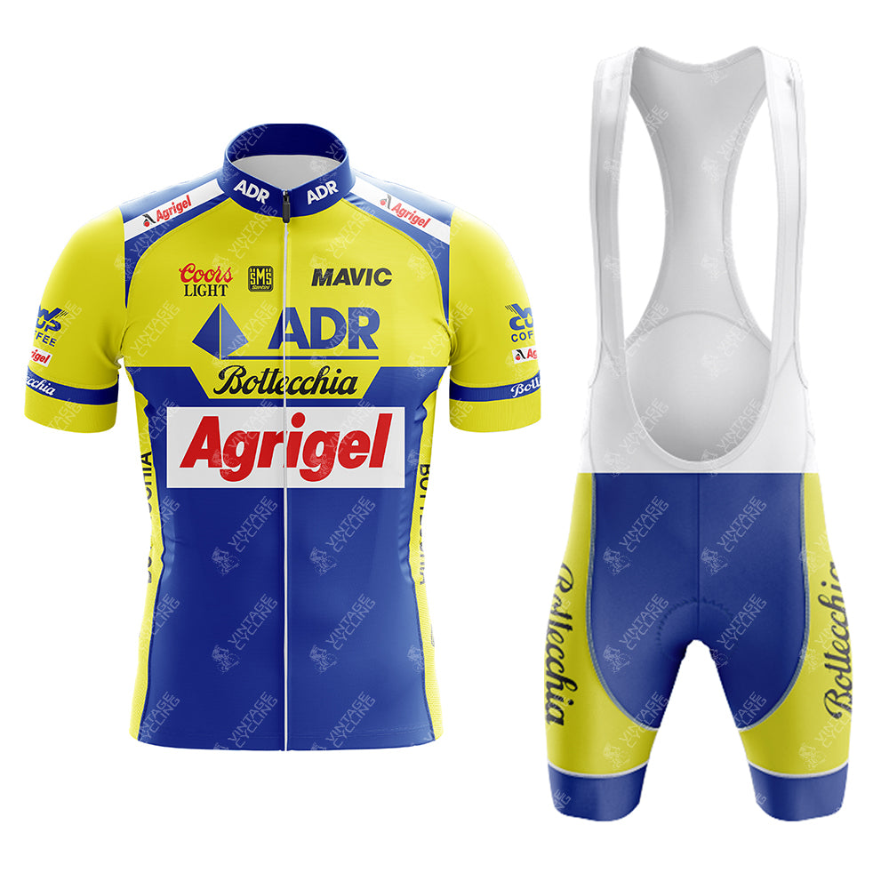 The 1989 ADR Retro Short Sleeve Cycling Set includes a vibrant yellow and blue jersey and matching bib shorts, adorned with Bottecchia and Coors Light logos. This vintage design features a front zipper for added style and functionality.