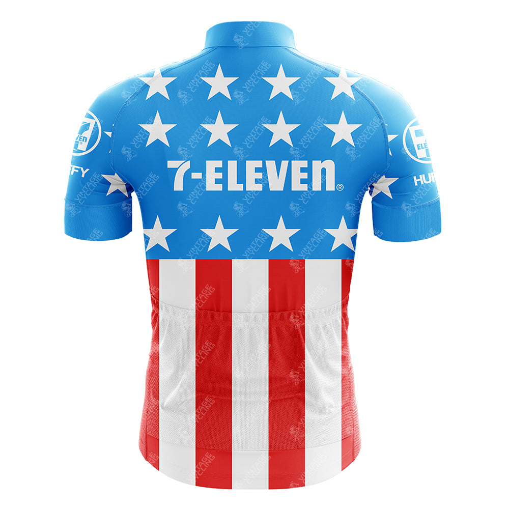 The reverse side reveals a blue short-sleeve cycling jersey graced with white stars, and red and white stripes, adorned with Huffy and Energizer logos. This 1990s 7-ELEVEN Retro Short Sleeve Cycling Set reflects the classic American flag style.