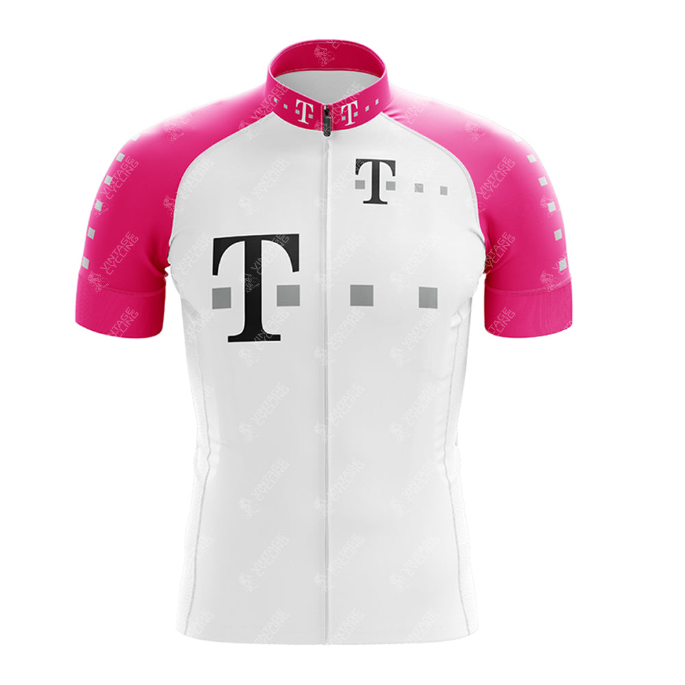 The T Retro Short Sleeve Cycling Set features a stylish cycling jersey with a white body, pink sleeves, and a bold black T logo on the chest. Smaller logos enhance the collar, while subtle branding complements the design alongside a sleek white center zipper. It pairs perfectly with matching shorts.