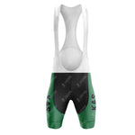 Front view of the KAS Green Retro Short Sleeve Cycling Set cycling bib shorts in green, black, and white with KAS on the green part. It includes a padded seat, shoulder straps, and an aerodynamic design echoing classic cycling aesthetics.