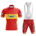 The BIC Red Retro Short Sleeve Cycling Set includes a red and yellow jersey and bib shorts with Bic logos and a cartoon figure. It features a zip-up top and white-strapped bib shorts, perfect for capturing the vintage cycling vibe.