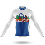 The Scotland Men Long Sleeve Cycling Jersey is white and blue, moisture-wicking, and features a mountain, trees, and a brown Bigfoot riding a bike. "Believe." appears in bold white letters on a red background.