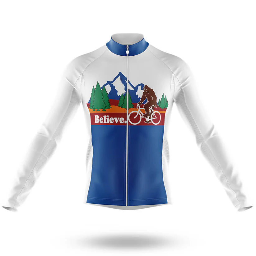 The Scotland Men Long Sleeve Cycling Jersey is white and blue, moisture-wicking, and features a mountain, trees, and a brown Bigfoot riding a bike. "Believe." appears in bold white letters on a red background.