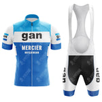The Gllane Retro Short Sleeve Cycling Set features a blue, white, and black jersey with a front zipper displaying gan, MERCIER, and HUTCHINSON logos. The vintage bib shorts have a white upper, black bottoms, and blue leg bands with gan branding.